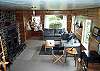 Lower level - Living room with TV/DVD, wood burning fireplace, hide a bed for additional sleeping and door out to large grassy backyard.