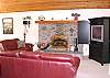 Upper level -  Living room with TV/DVD and wood burning fireplace.  Slider to back deck.