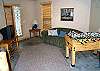 Lower level family room with TV/DVD/VCR, hide-a-bed for additional sleeping, foos ball table and wet bar.