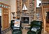 Second view of Upstairs living room with Large screen TV/DVD, fireplace and partial ocean views