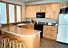 Lower level - Fully equipped kitchen with breakfast bar for 5.  Views of 9th Fairway of Golf Course.
