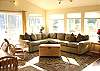 Upper level-Living room with TV/DVD, wood stove and slider to deck.