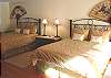 Upper level - Bedroom wtih two Queen beds, TV, ocean views and a slider out to backyard/patio.