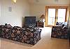 Upper level - Bedroom/Sitting room with a Queen bed and Twin bed (TV is non functional) with a door out to the private deck.