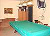 Pool table room with couch and TV.