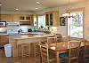 Upper level - Fully equipped kitchen with breakfast bar for 3 and dining table for 6.