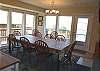 Dining table for 8 with two extra chairs, beautiful ocean views and door out to deck.