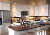 Lower level - Fully equipped kitchen with Cherry wood counter tops and a breakfast bar for 4.  Spectacular ocean views.