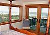 Second view - Upper level - Bedroom with a Queen bed, door to private deck and spectacular ocean views.