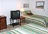 Second view - Lower level - Bedroom with a Queen bed and Twin bed, TV/VCR and peak ocean views.