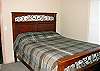 Upper level - Master bedroom with a Queen bed and a private bathroom with a tub and shower.