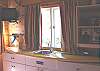 Custom built bunk house in backyard with Twin bunk bed, TV/DVD and sink.