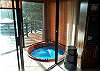 Indoor hot tub with slider to living room and upper balcony