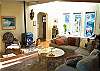 Third view - Lower level -  Living room with large sectional, 1/2 bath, 27" flat screen TV/DVD, glass front pellet stove and double doors out to back deck.
