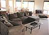 Second view - Upper level - Living room with TV/DVD/VCR, bench seat with puzzels & games and a glass front wood stove.