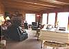 Living room with TV/VCR/DVD, wood burning fireplace, mini grand piano and ocean views.