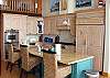 Lower level - Fully equipped kitchen with breakfast bar for 3 and gas cook top stove.