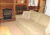 Second view of Living room with TV/DVD/VCR, gas wood stove and slider to deck.