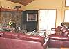 Second view - Upper level -  Living room with TV/DVD and wood burning fireplace.  Slider to back deck.