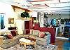 Lower level - Living room with large sectional, 1/2 bath, 27" flat screen TV/DVD, glass front pellet stove and double doors out to back deck.
