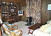 Upper level - Living room with hide a bed for additional sleeping, TV/DVD, glass front pellet stove and ocean views.