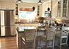 Fully equipped kitchen with stainless steel appliances and  Breakfast bar for 3.