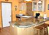 Fully equipped kitchen with gas cook top and breakfast bar for 3.