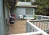 Wrap around deck with ocean views with Charcoal BBQ and patio furniture.