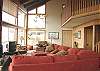 Lower level - Living room with large sectional, TV/DVD, large picture windows and wood burning fireplace.