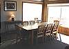 Lower level - Dining table for 10 with slider out to deck and ocean views.