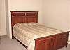 Lower level - Bedroom with a Queen bed and TV with a walk-in closet with games.