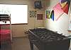 Second view of Lower level bedroom with Two Twin/Double Bunk beds, foos ball table and wall mount TV/VCR.