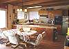 Fully equipped kitchen and dining table with two leaves that can seat 8 with ocean views.