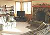 Second view - Living room with two hide a bed couches for additional sleeping, flat screen TV/VCR/DVD and wood burning fireplace.