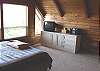 Second view - Upstairs loft style bedroom (right side) with Queen bed, wood stove, TV/VCR, CD player, full bathroom and beautiful ocean/mountain views.