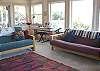 Third view - Upper level-Living room with flat screen TV/DVD, CD stereo, wood stove insert and spectacular ocean views.