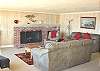 Lower Level - Living room with TV/VCR, wood burning fireplace and spectacular ocean views.