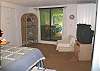 Second view - Lower level - Bedroom with a Double size bed and TV with slider out to backyard.