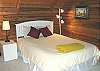 Third view - Upstairs loft style bedroom (left side) with Queen bed and full bathroom.