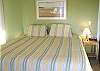 Lower level - Master Bedroom with a King bed, TV/DVD, slider out to deck and ocean views.  Private bathroom with a tub and shower.