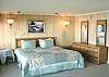 Upper level - Master Bedroom with a King bed, spectacular ocean view with private balcony overlooking the ocean and a private bathroom with shower.