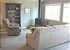 Upstairs living/sitting area with glass front wood stove, views of 2nd hole of golf course - adjacent TV area