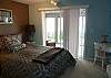 Downstairs bedroom with Queen bed, slider to sun room