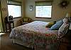 Upper level Master Bedroom with a King bed, TV and slider to deck.