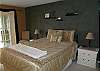 Downstairs bedroom with Queen bed, slider to sun room