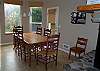 Lower level - Dining tabel for 6 plus a highchair and a door out to grassy backyard.