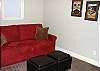 Upper level - Sitting room overlooks the living room with a hide-a-bed for additional sleeping and a door to the upper balcony outside.