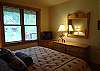 Master bedroom with TV and treed views