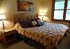 Master bedroom with King bed, new bedding, TV and private bath