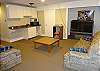 Lower level game room has a sleeper sofa and large TV